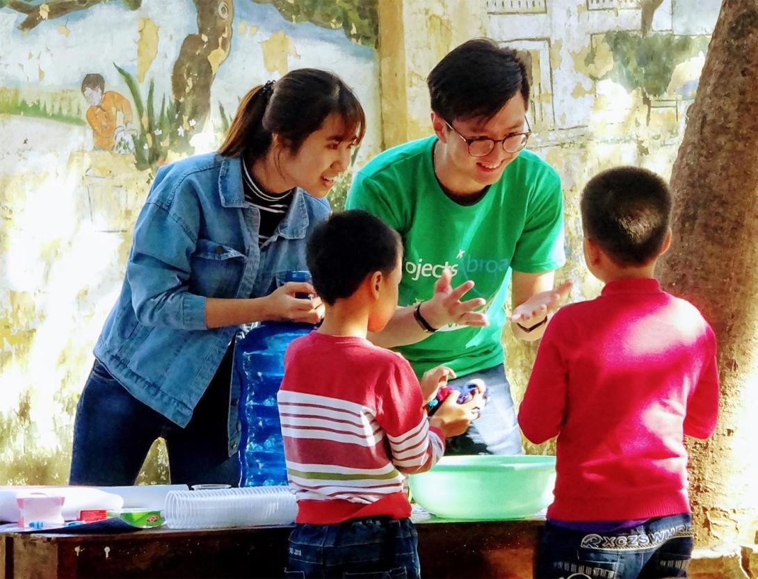 Children learn how to wash their hands properly from Childcare volunteers in Vietnam Two Projects Abroad volunteers in Vietnam help teach kids proper hand washing techniques